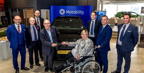 Rt Hon Robert Halfon handing over the keys to Johanna new Motability Scheme car. They are both smiling at the camera.