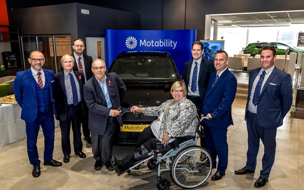 Rt Hon Robert Halfon handing over the keys to Johanna new Motability Scheme car. They are both smiling at the camera.