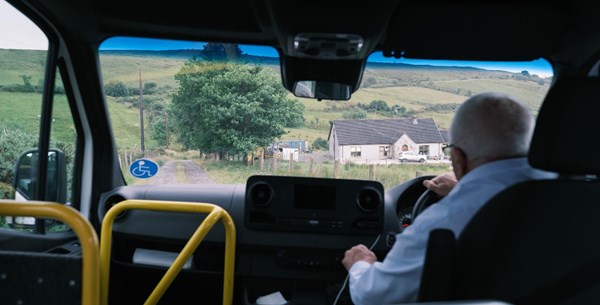 Community transport driver, driving an accessible mini-bus through rural Northern Ireland. 