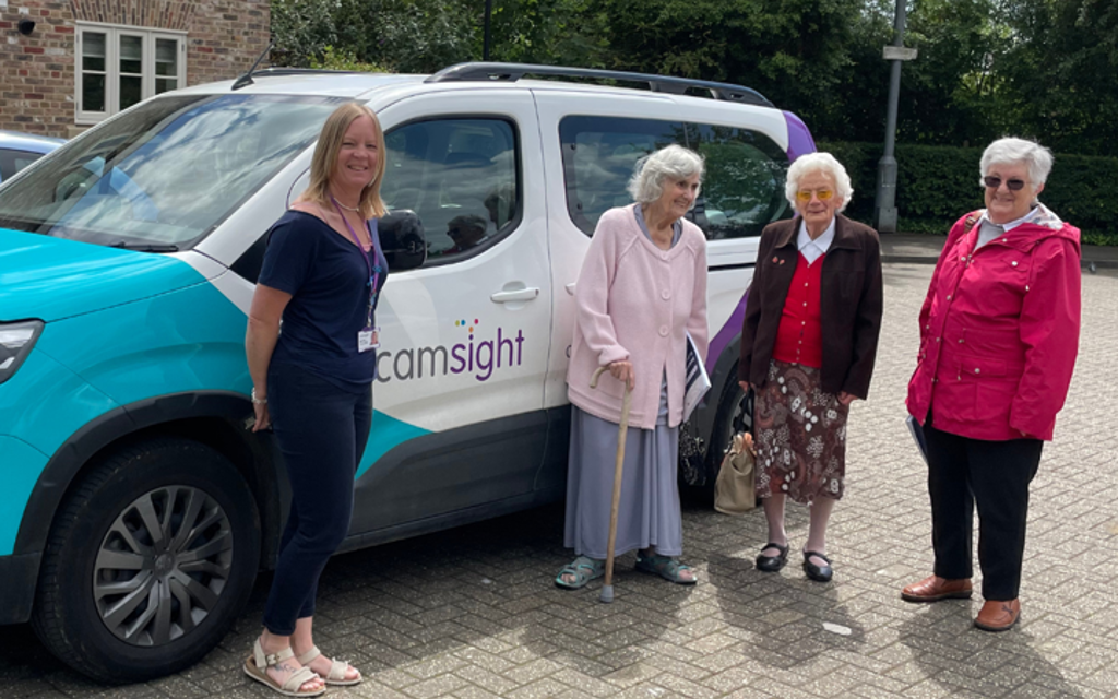 CamSight vehicle with four women in front smiling. 