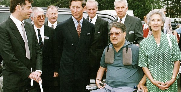King Charles III presentation at the mobility roadshow 1993. King Charles III is smiling next to Motability Scheme customers. 