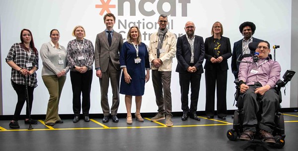 A group photo smiling in front of the NCAT logo which sits on a presentation backdrop. Caption left to right: Stephanie McPherson-Brown, Kay Atkin, Emily Nash, Robert McLaren, Cathryn Thompson-Goodwin, Professor Paul Herriotts, Gordon McCullough, Catharine Brown, Michael Edwards, Clive Gilbert 
